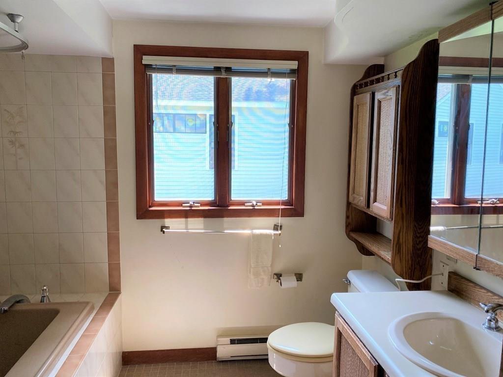 25 Clearwater Road Newton, MA 02462 - Photo 11 of 23 a bathroom with a sink a toilet and a mirror