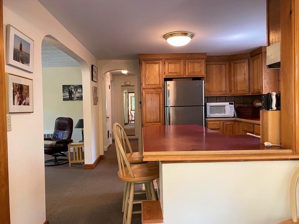 25 Clearwater Road Newton, MA 02462 - Photo 7 of 23 a kitchen with kitchen island a counter top space cabinets and stainless steel appliances