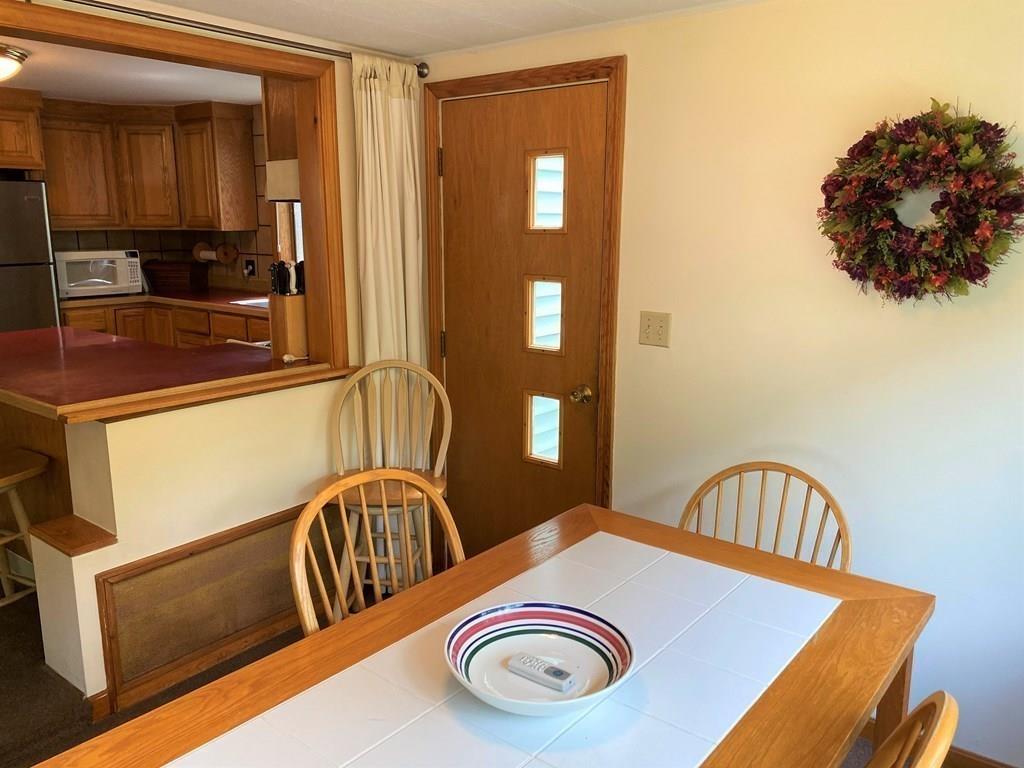 25 Clearwater Road Newton, MA 02462 - Photo 9 of 23 a view of a kitchen area with furniture and chandelier