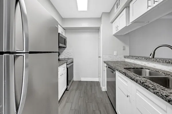 a kitchen with a sink stove and refrigerator