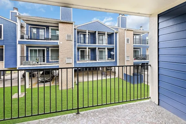 a view of a brick house with an outdoor space