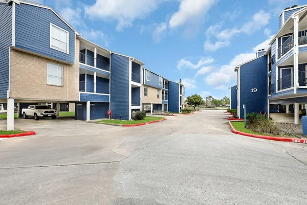 a view of a hallway with wooden shelves