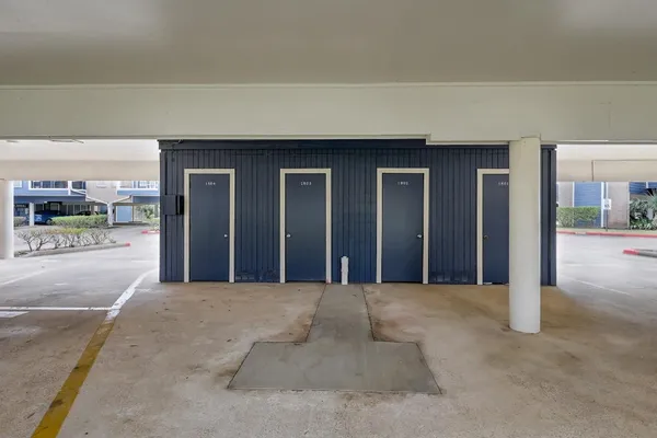 a view of a building with a yard and sitting area