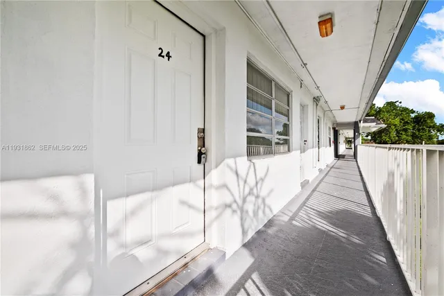 a view of a bedroom with wooden floor and stairs