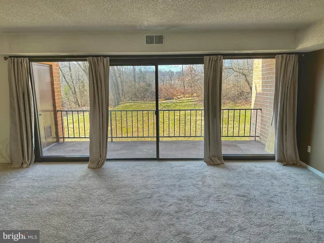 a view of an empty room with a large window