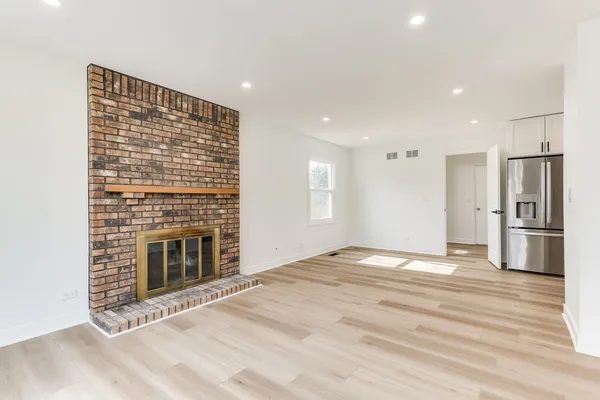 a view of an empty room with a fireplace