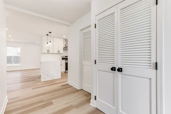 a view of a kitchen with wooden floor and a sink