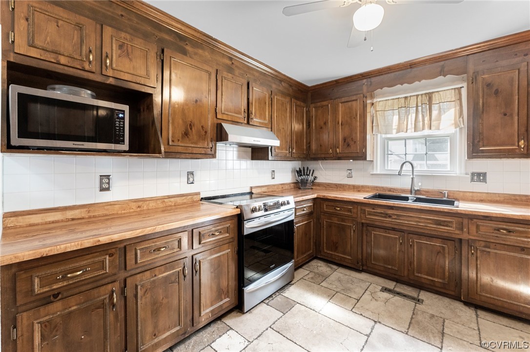 4717 Crossgate Road Chester, VA 23831 - Photo 13 of 34 a kitchen with cabinets stainless steel appliances and a sink