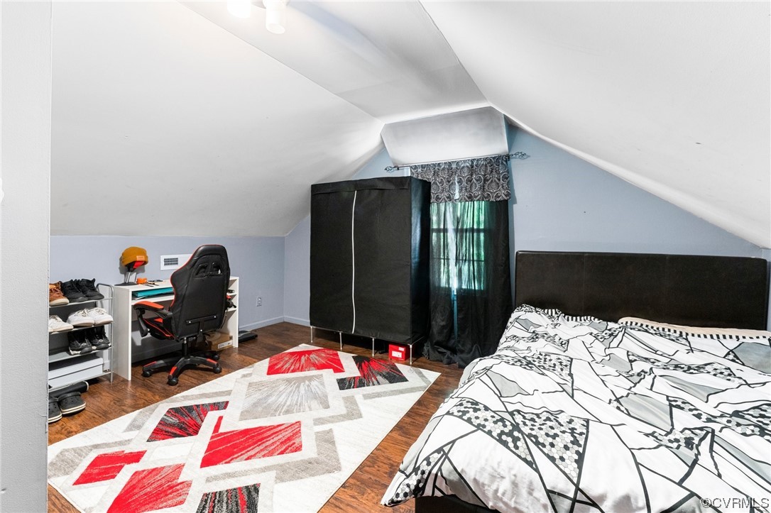 4717 Crossgate Road Chester, VA 23831 - Photo 26 of 34 a bedroom with a bed and a chandelier