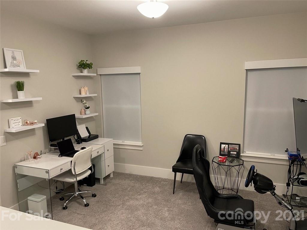 3508 Ritch Avenue Charlotte, NC 28206 - Photo 17 of 33 a view of a workspace with furniture and a gate