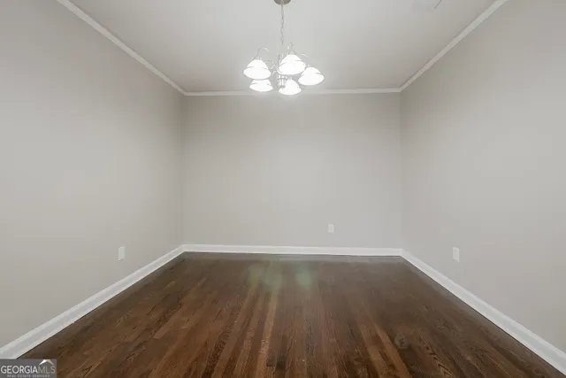 a view of a room with wooden floor and a window