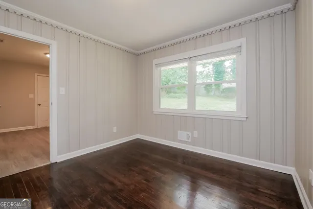a view of a room with wooden floor and windows in it