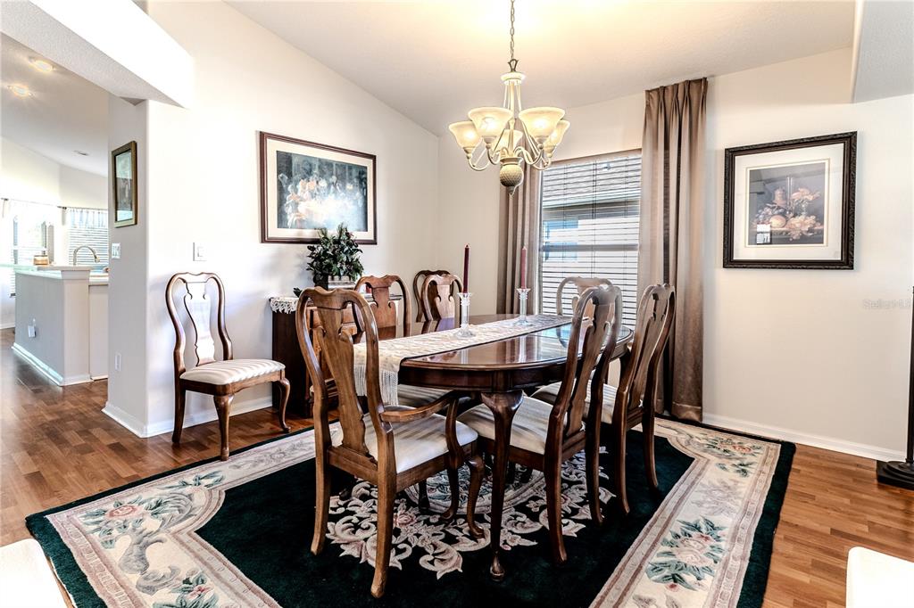150 Gordham Court Spring Hill, FL 34609 - Photo 15 of 71 a view of a dining room with furniture and chandelier