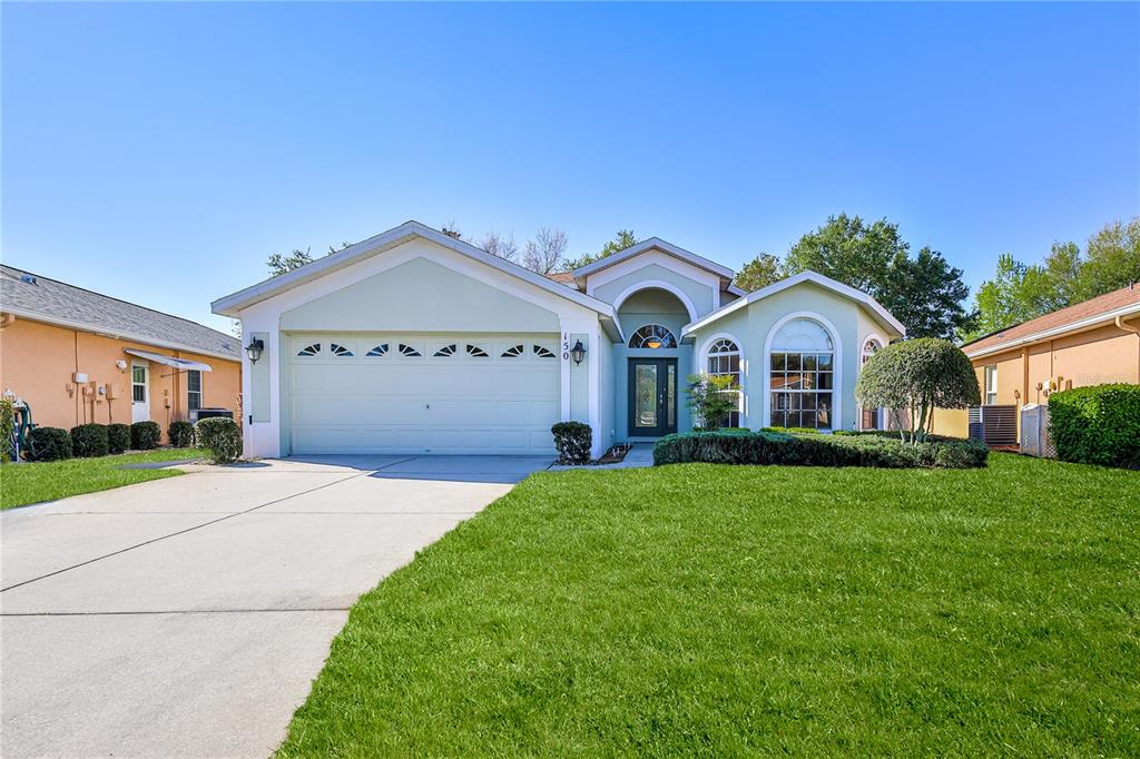 150 Gordham Court Spring Hill, FL 34609 - Photo 2 of 71 a front view of a house with a yard and garage