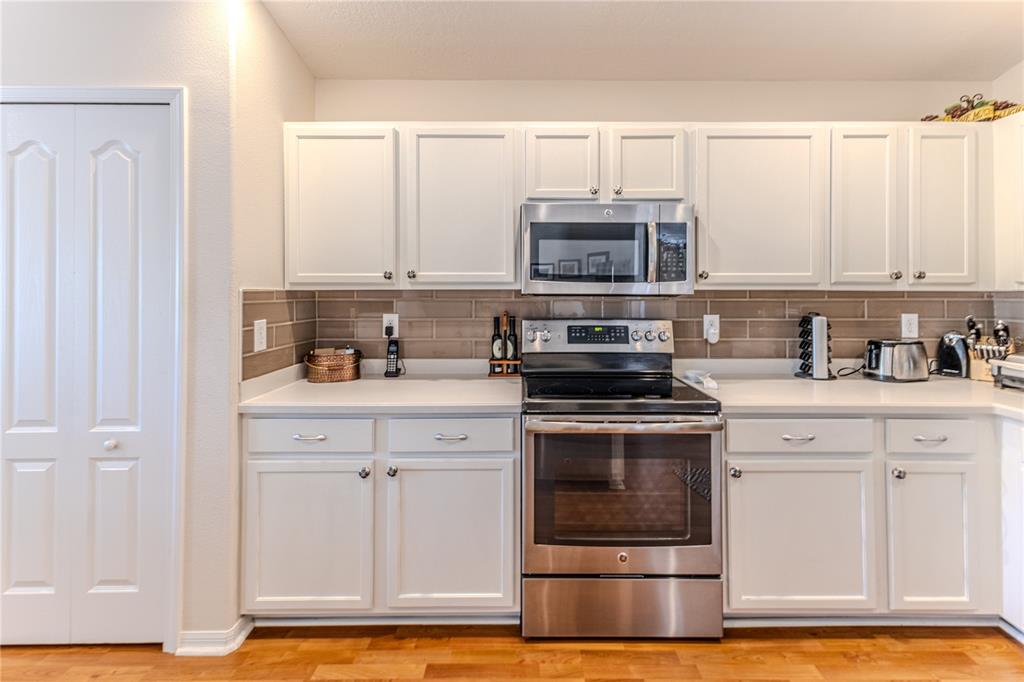 150 Gordham Court Spring Hill, FL 34609 - Photo 25 of 71 a kitchen with granite countertop a stove sink and cabinets