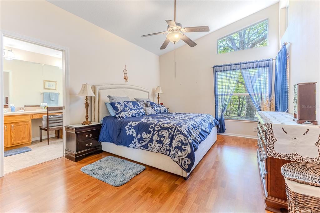 150 Gordham Court Spring Hill, FL 34609 - Photo 36 of 71 a bedroom with a large bed and a chandelier