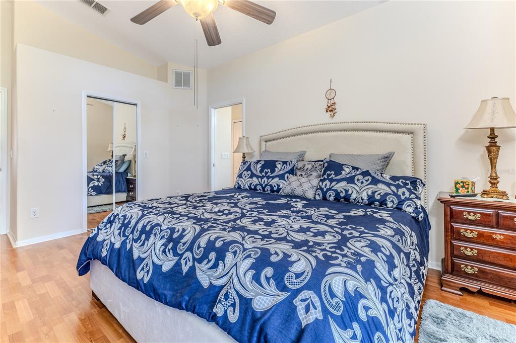 150 Gordham Court Spring Hill, FL 34609 - Photo 37 of 71 a large bed sitting in a bedroom and chandelier