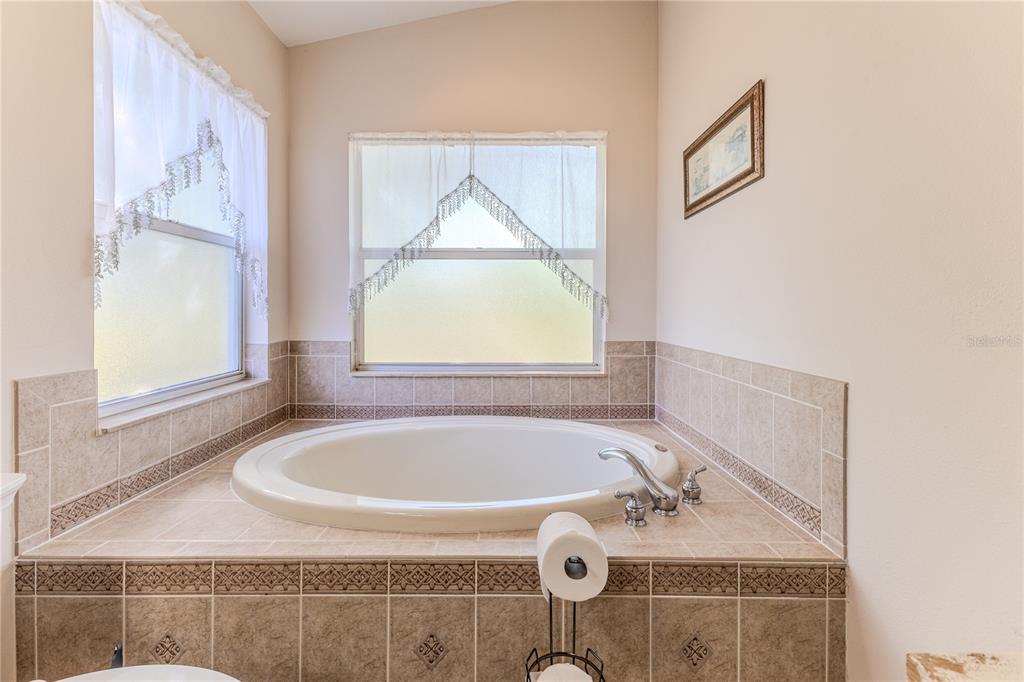 150 Gordham Court Spring Hill, FL 34609 - Photo 40 of 71 a bathroom with a tub and a window