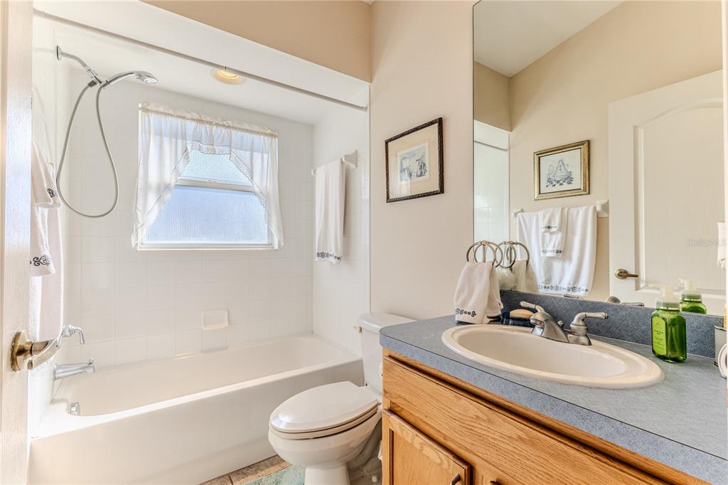 150 Gordham Court Spring Hill, FL 34609 - Photo 48 of 71 a bathroom with a granite countertop sink a toilet and shower