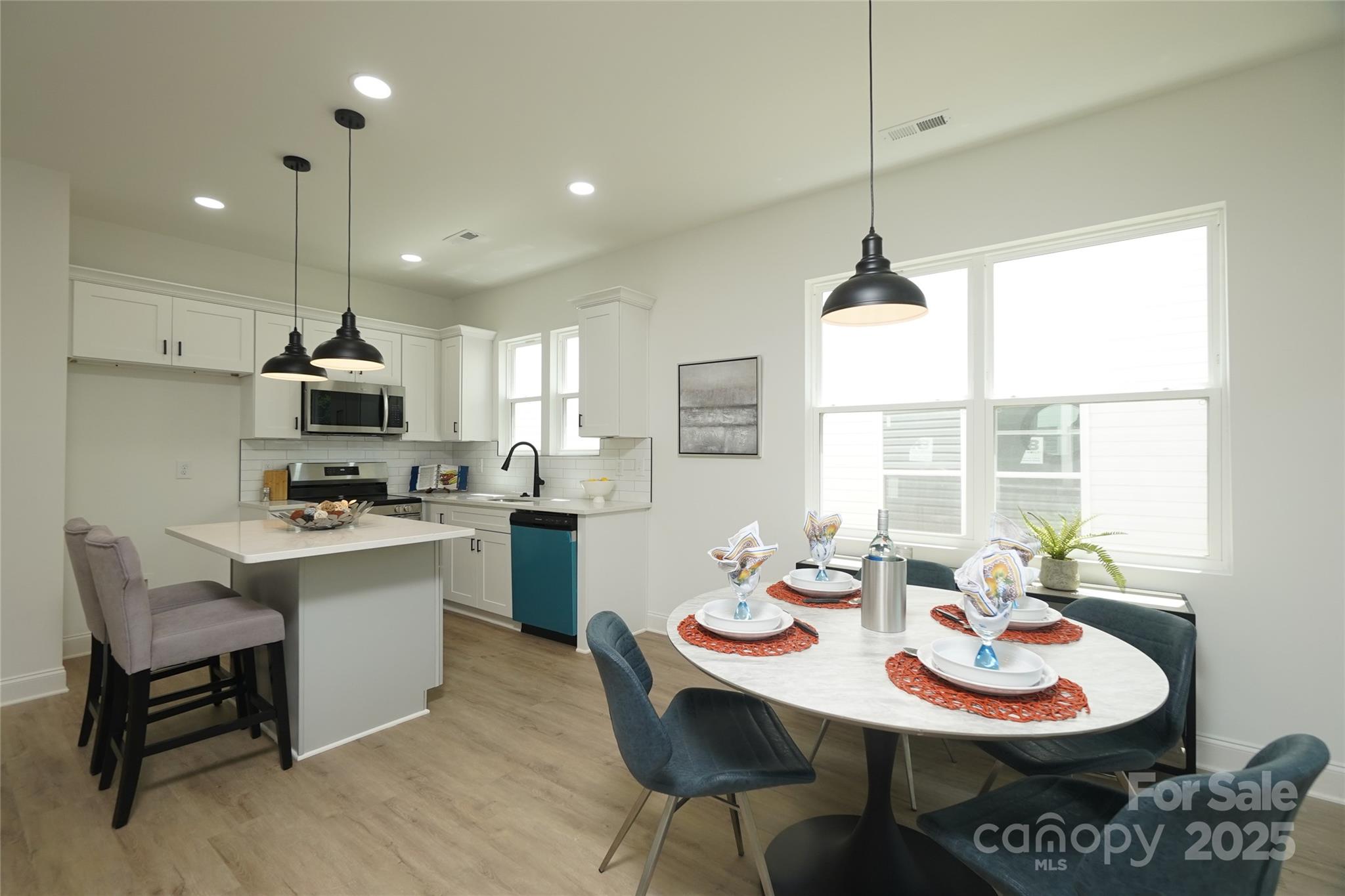 3224 Sam Wilson Road Charlotte, NC 28214 - Photo 12 of 32 a kitchen with a dining table and chairs