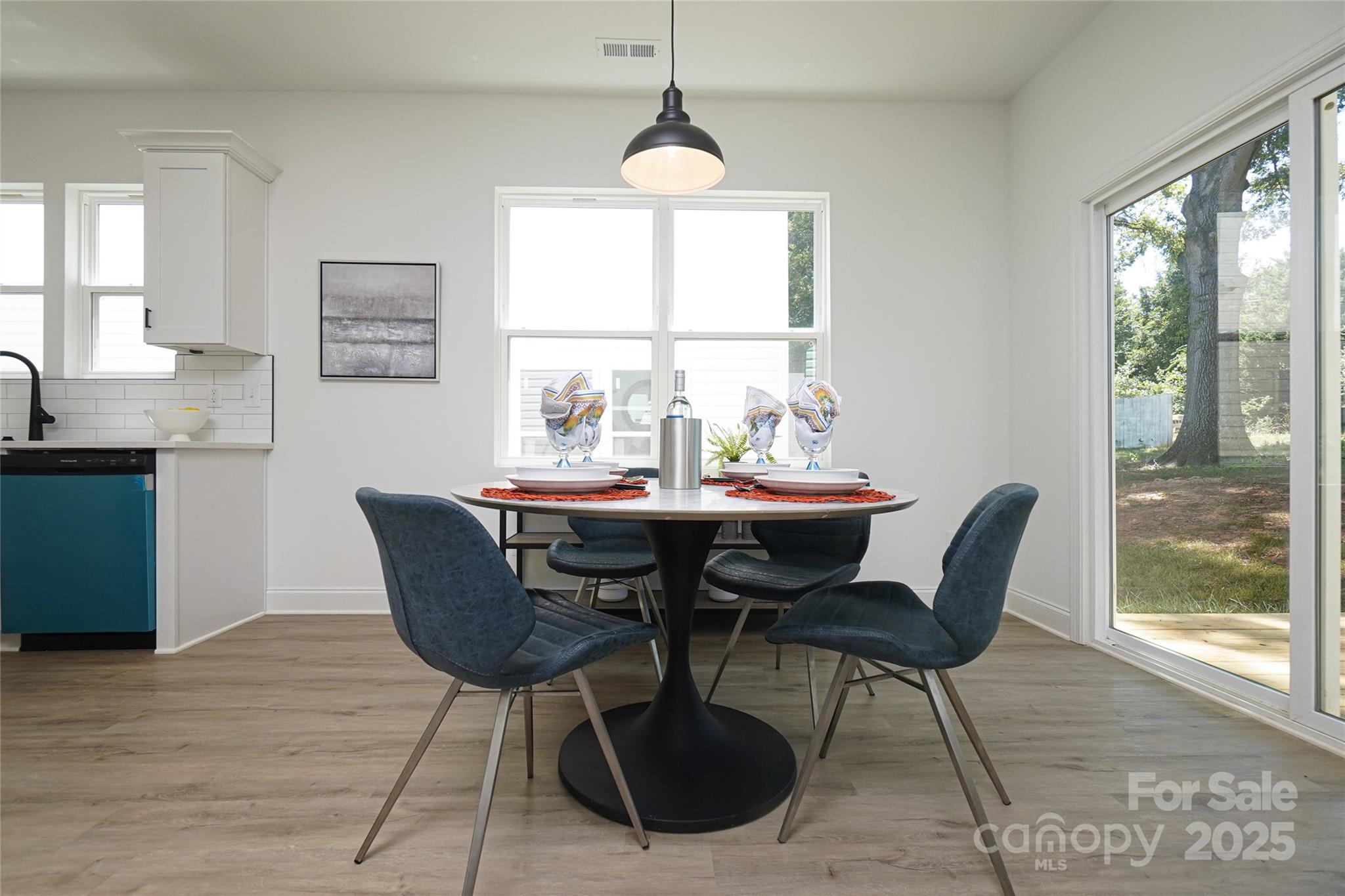 3224 Sam Wilson Road Charlotte, NC 28214 - Photo 13 of 32 a dining room with furniture a chandelier and wooden floor