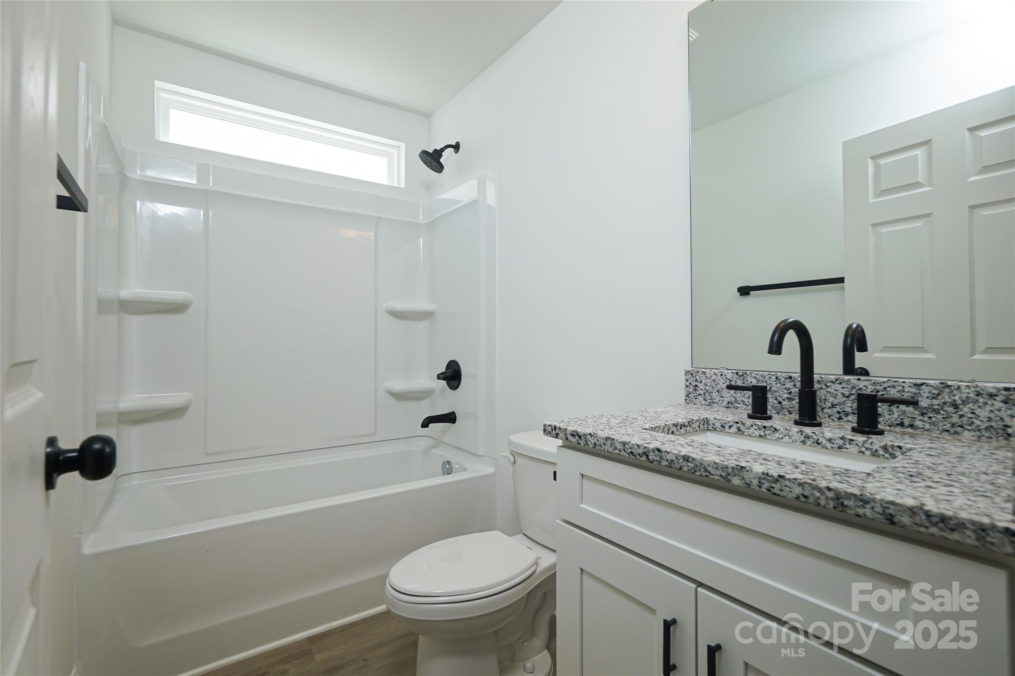 3224 Sam Wilson Road Charlotte, NC 28214 - Photo 28 of 32 a bathroom with a granite countertop sink toilet and shower