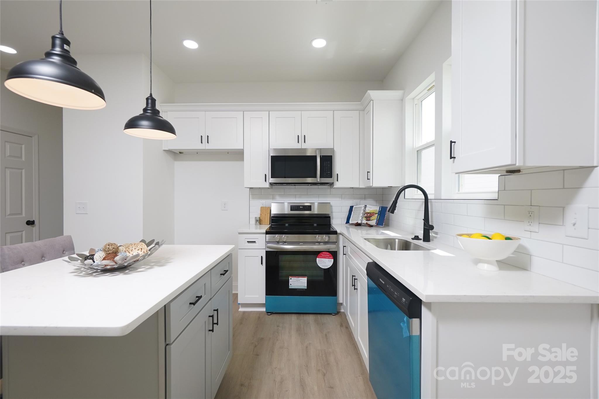 3224 Sam Wilson Road Charlotte, NC 28214 - Photo 7 of 32 a kitchen with a sink stove and microwave