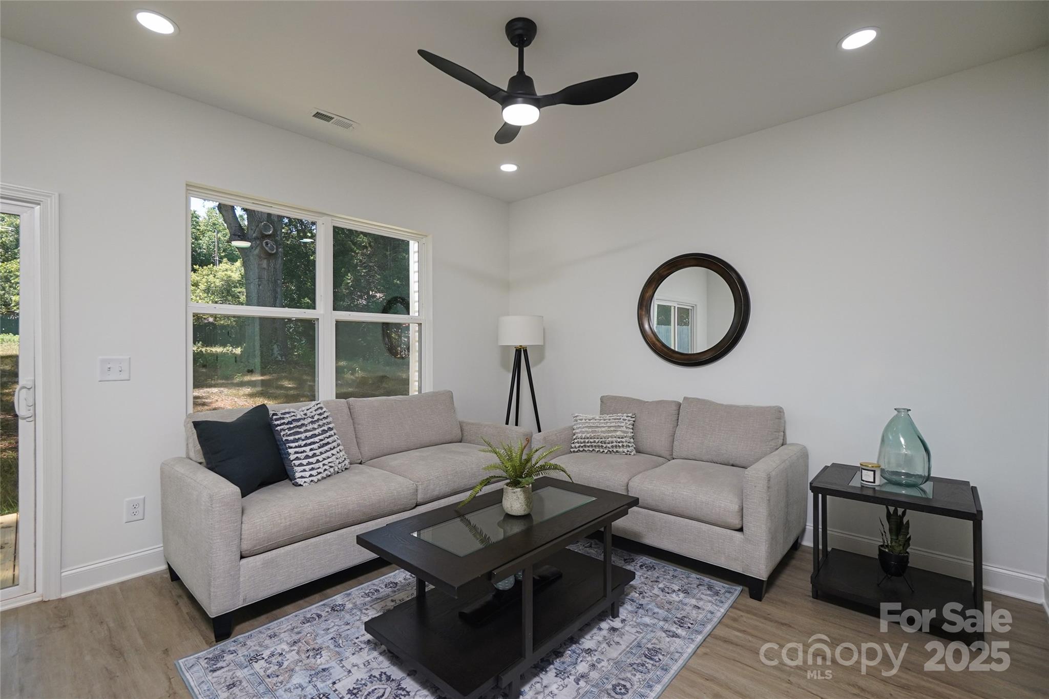 3224 Sam Wilson Road Charlotte, NC 28214 - Photo 10 of 32 a living room with furniture a rug and a window