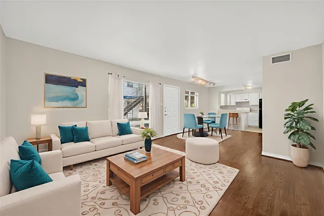 a living room with furniture and wooden floor