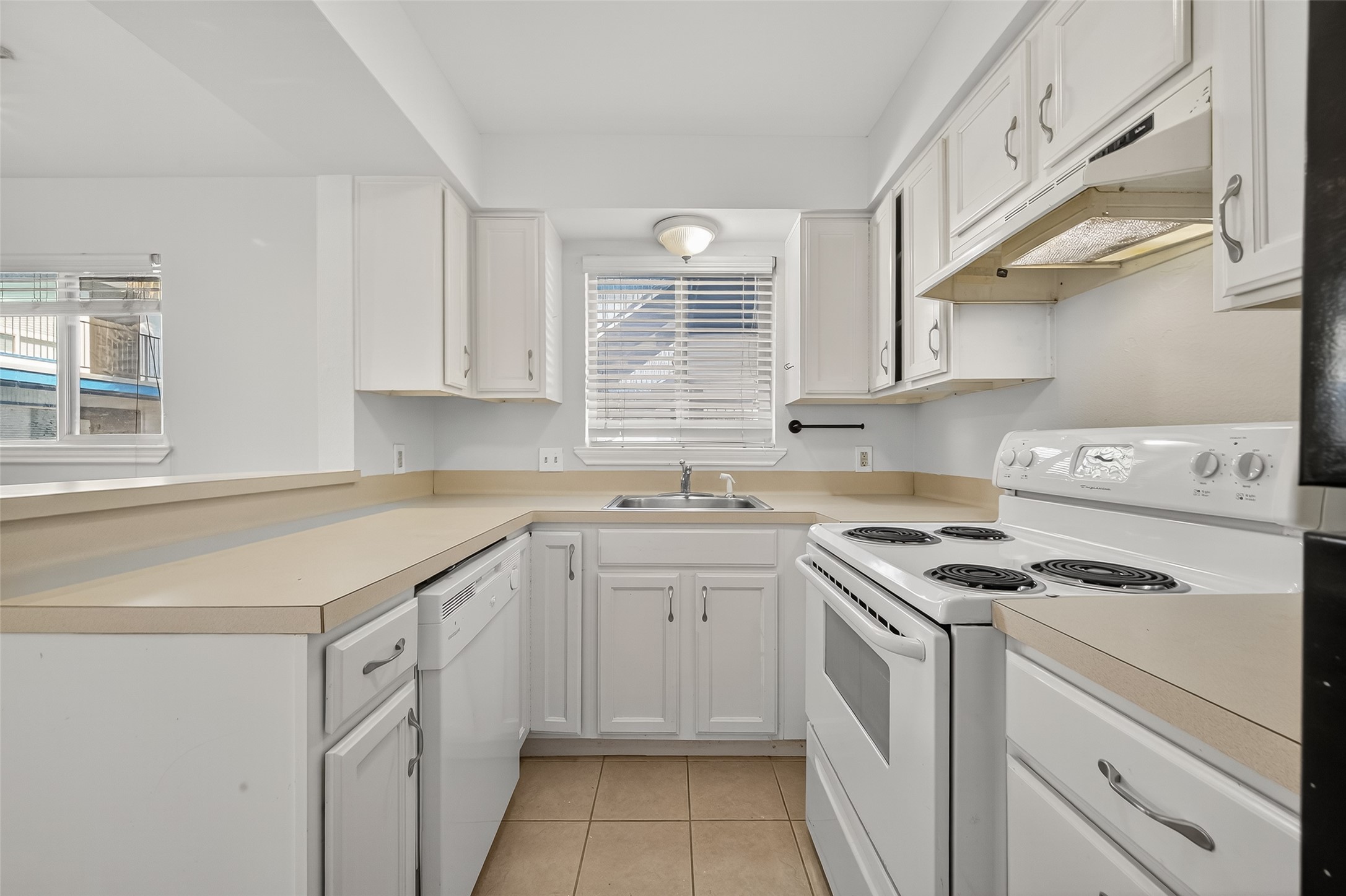 2020 Huldy Street, Unit 1 Houston, TX 77019 - Photo 18 of 30 a kitchen with cabinets appliances a sink and a window