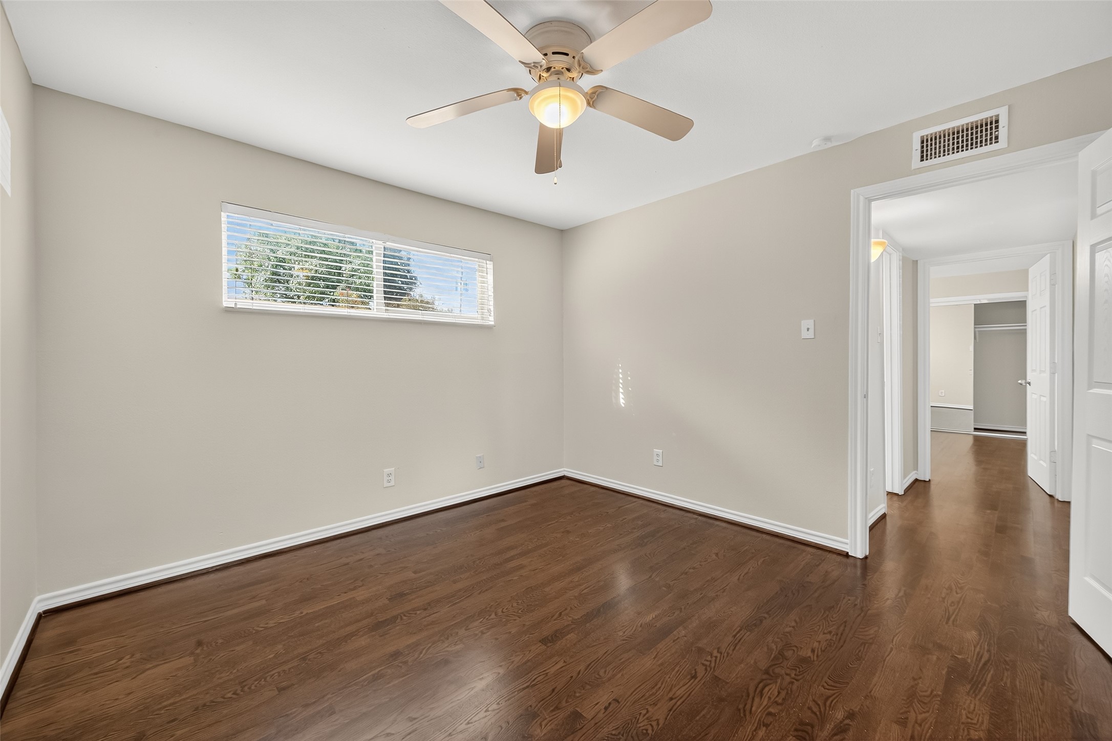 2020 Huldy Street, Unit 1 Houston, TX 77019 - Photo 28 of 30 a view of an empty room with window and wooden floor