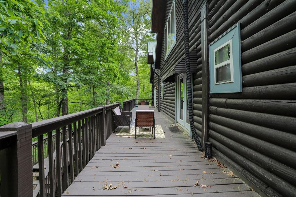 101 Yellow Bluff Road Dahlonega, GA 30533 - Photo 4 of 20 a balcony of a house with wooden floor and outdoor seating
