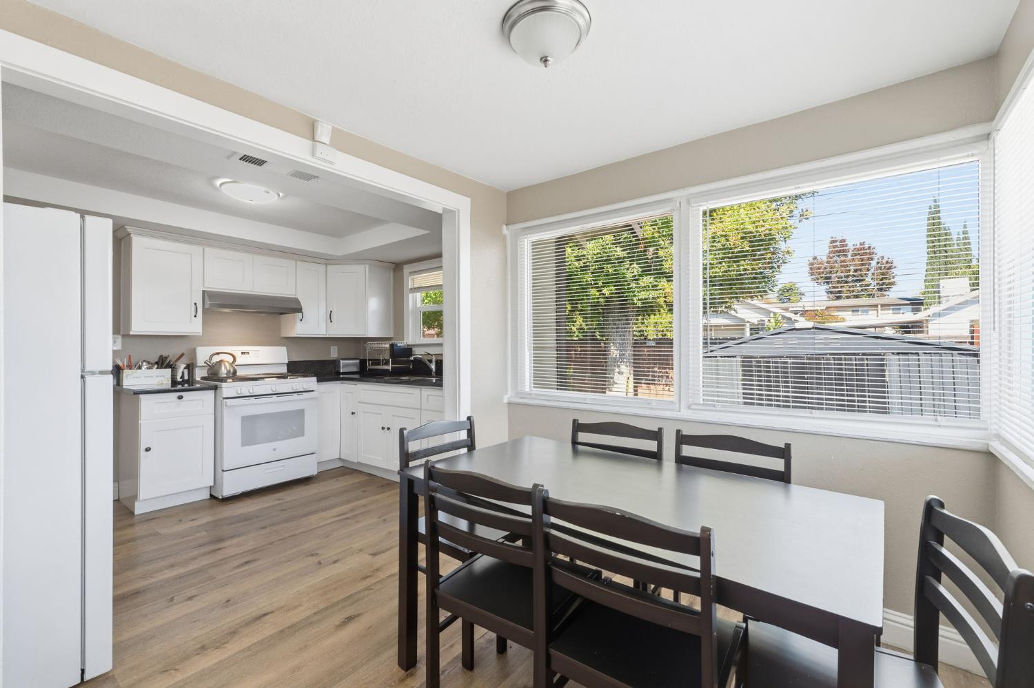 321 North Orange Avenue Exeter, CA 93221 - Photo 13 of 37 a kitchen with a table chairs stove and cabinets