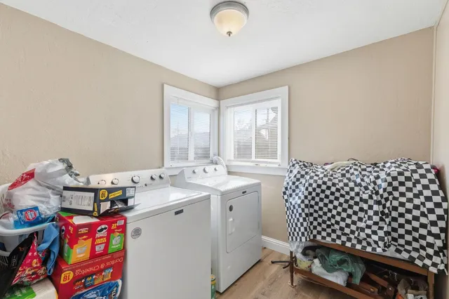 a bedroom with a bed and a dresser with mirror