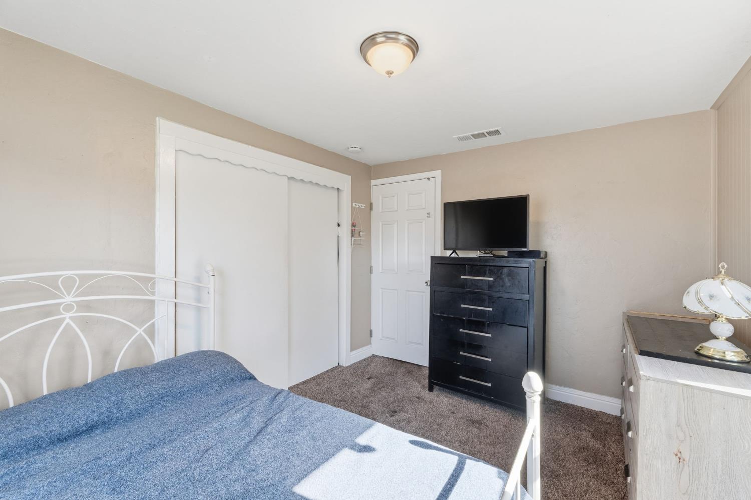 321 North Orange Avenue Exeter, CA 93221 - Photo 16 of 37 a living room with furniture and a flat screen tv