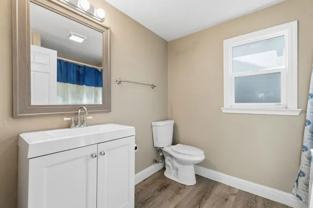 a bedroom with a bed and with painting on the wall