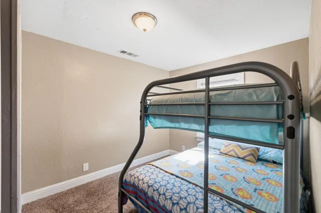 a bedroom with a bed and a book shelf