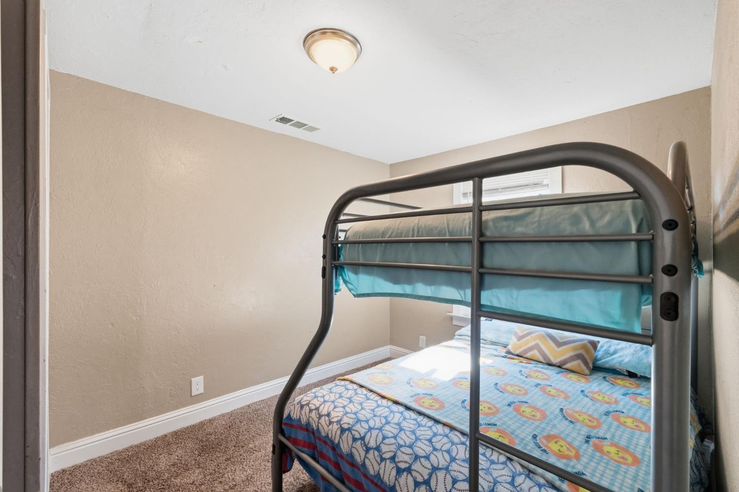 321 North Orange Avenue Exeter, CA 93221 - Photo 18 of 37 a bedroom with a bed and with painting on the wall