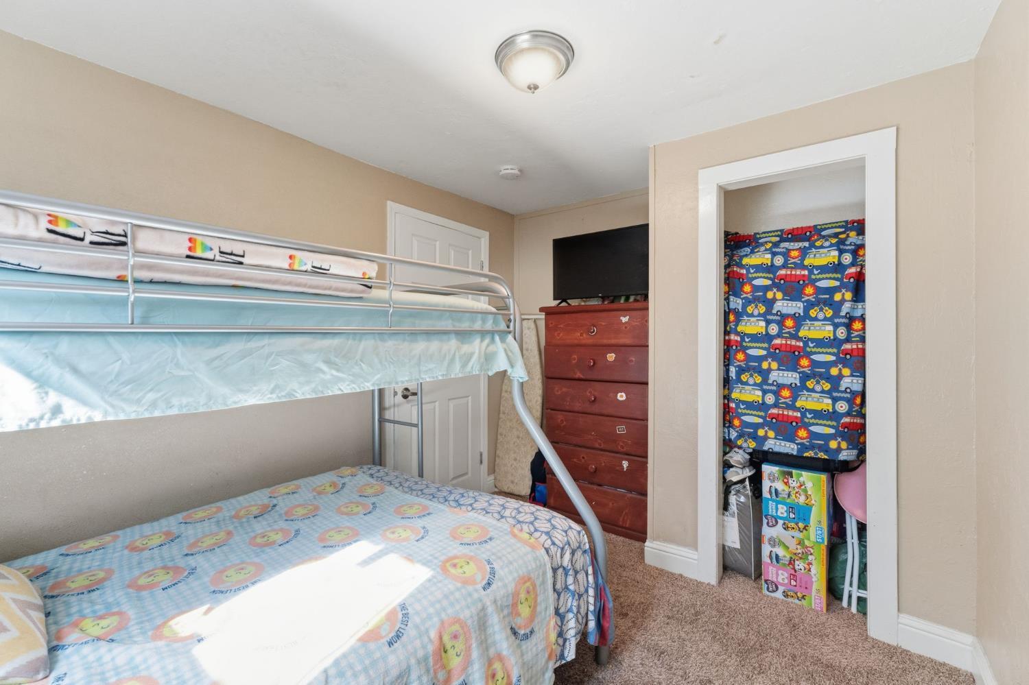 321 North Orange Avenue Exeter, CA 93221 - Photo 19 of 37 a bedroom with a bed and a book shelf