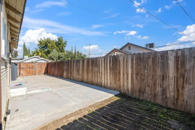 a view of a house with wooden fence