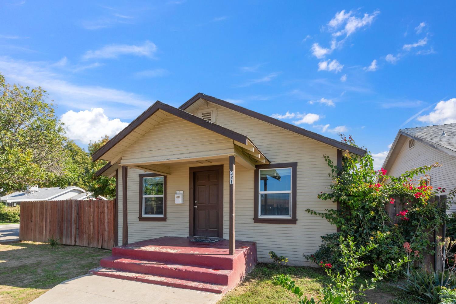 321 North Orange Avenue Exeter, CA 93221 - Photo 3 of 37 a view of a house with a small yard and potted plants
