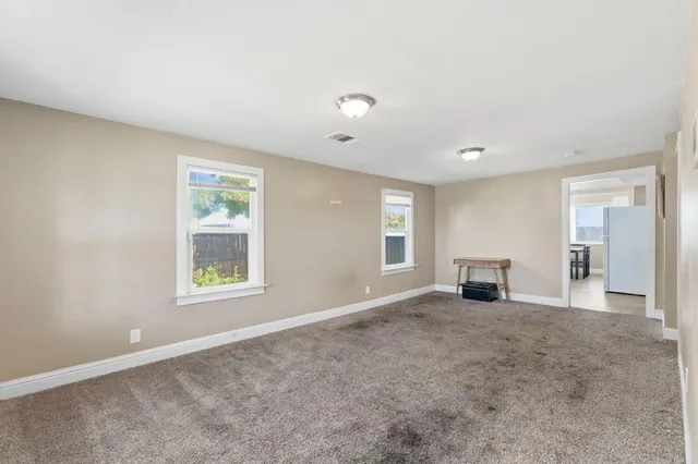 an empty room with windows and closet