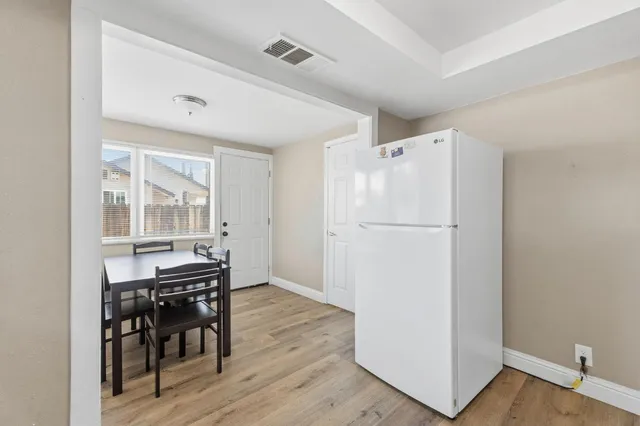 a kitchen with a table chairs stove and cabinets