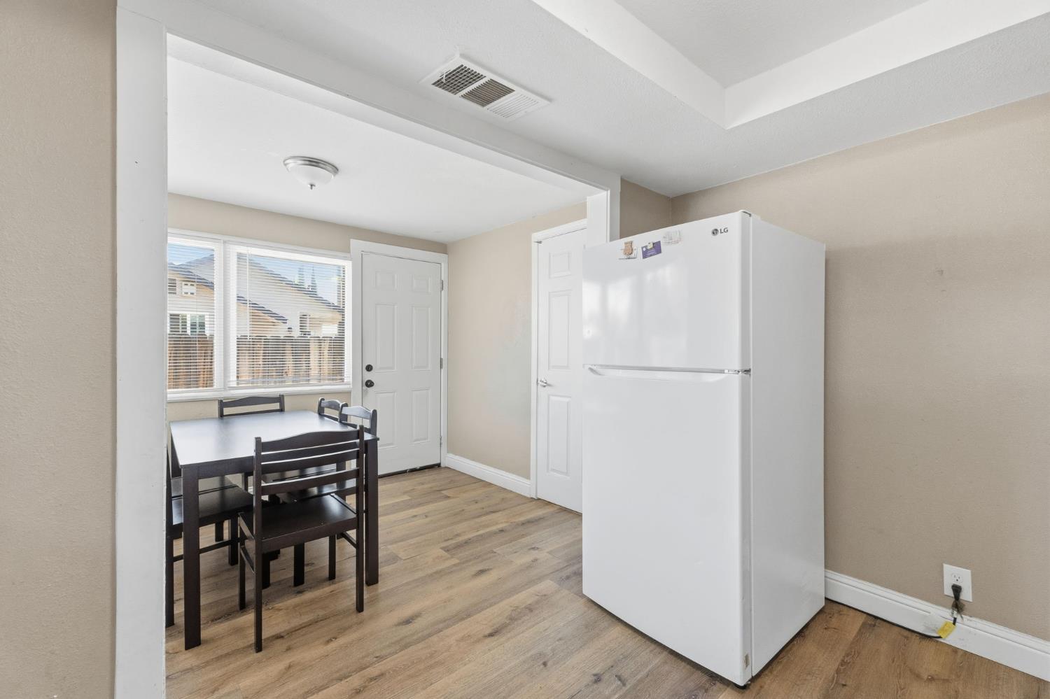 321 North Orange Avenue Exeter, CA 93221 - Photo 9 of 37 a view of kitchen with refrigerator and wooden floor