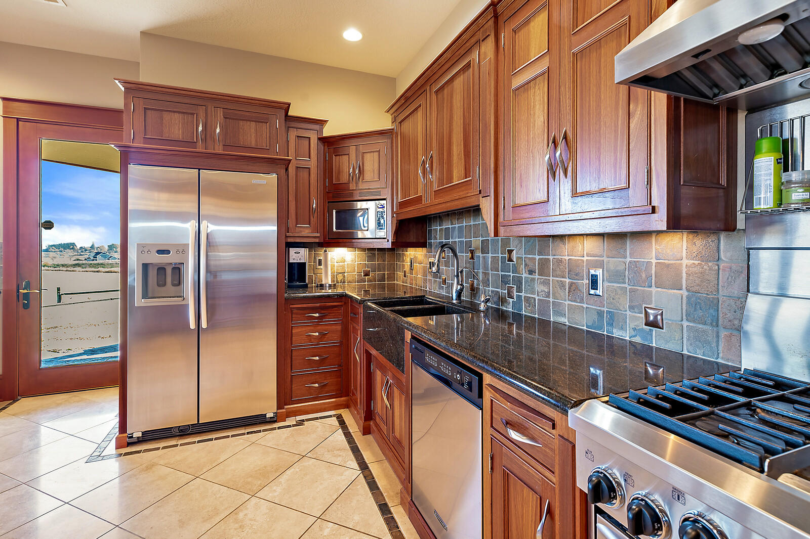 5405-5413 Seven Oaks Road Central Point, OR 97502 - Photo 29 of 65 a kitchen with stainless steel appliances granite countertop a refrigerator and a stove