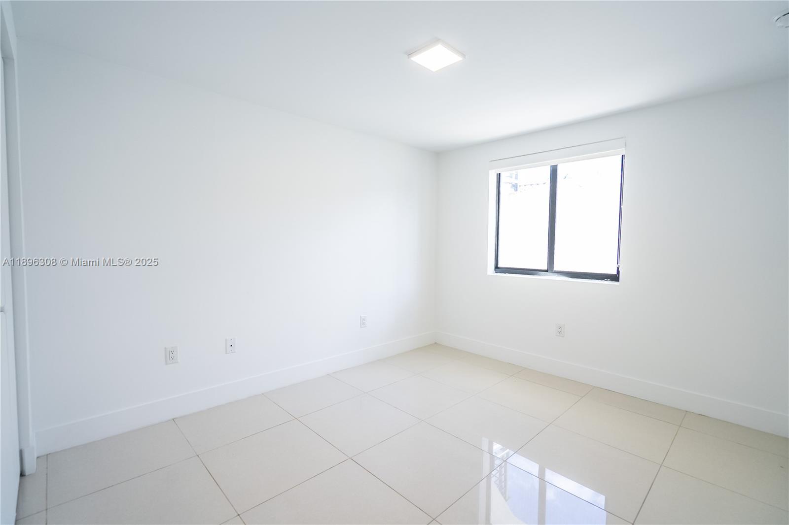 1971 Bay Drive, Unit 102 Miami Beach, FL 33141 - Photo 12 of 24 an empty room with windows