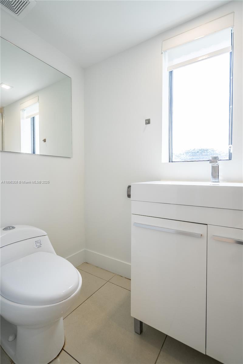 1971 Bay Drive, Unit 102 Miami Beach, FL 33141 - Photo 16 of 24 a bathroom with a toilet sink and mirror