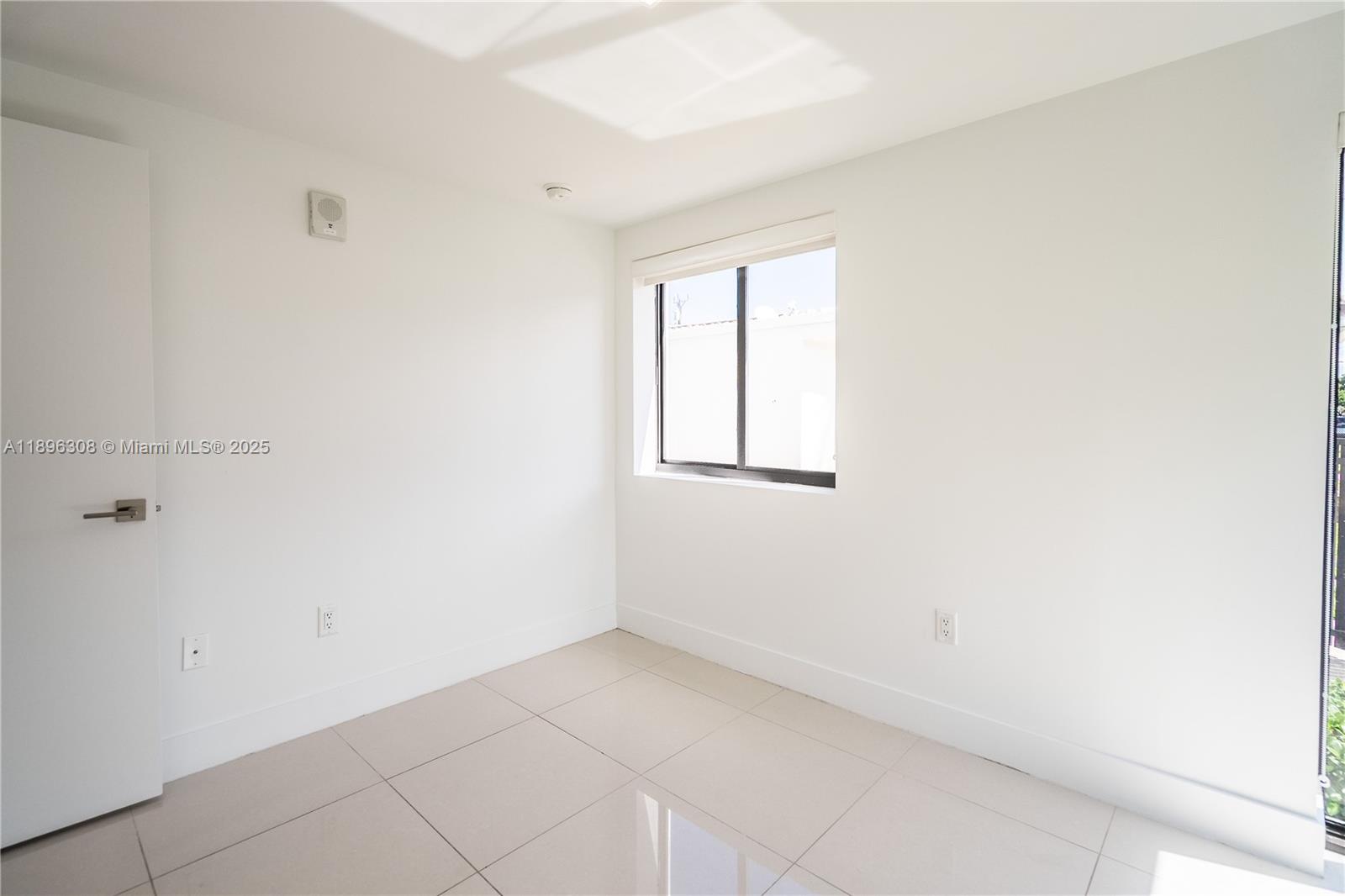 1971 Bay Drive, Unit 102 Miami Beach, FL 33141 - Photo 9 of 24 a view of an empty room with a window