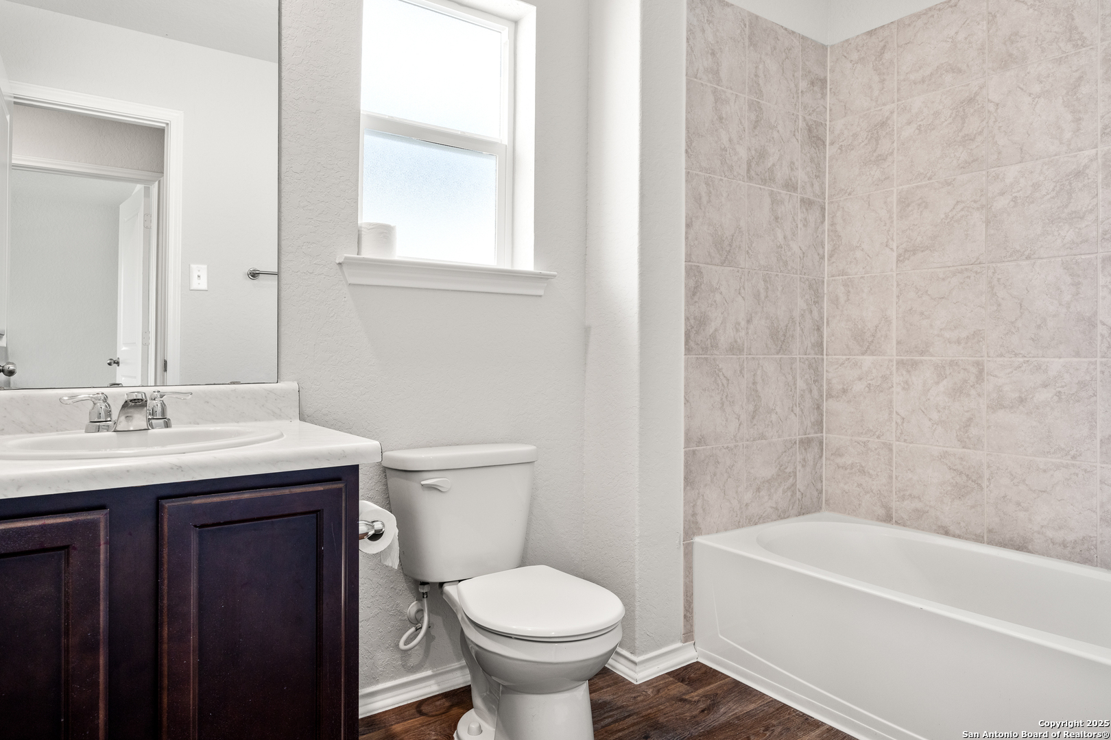 208 Greater Scaup San Antonio, TX 78253 - Photo 13 of 18 a bathroom with a granite countertop toilet a sink and a bathtub