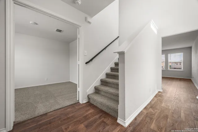 a view of entryway and hall with wooden floor